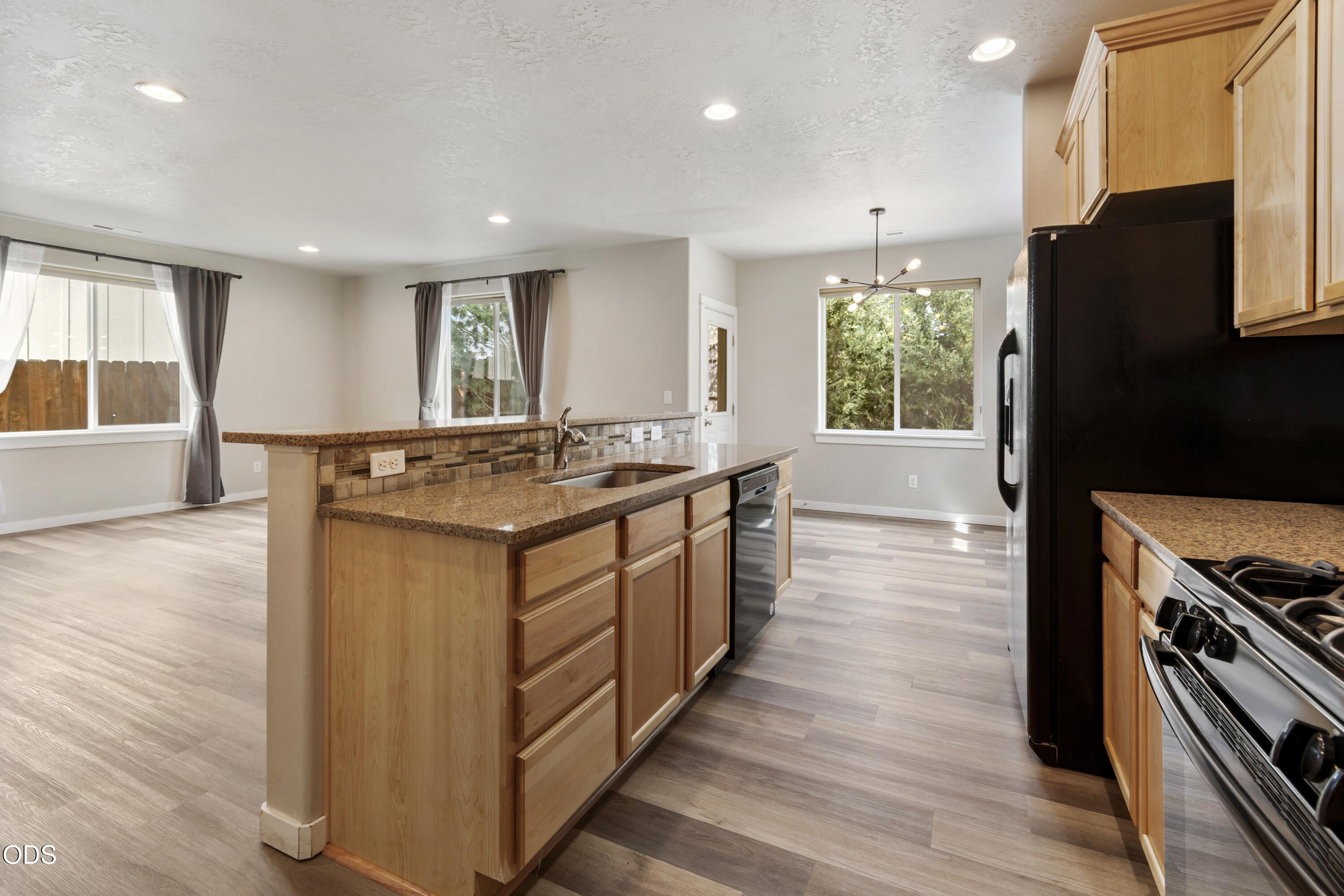 21332 Oconnor Way Bend, OR 97701 - Photo 14 of 33 a kitchen with stainless steel appliances granite countertop a stove and a refrigerator