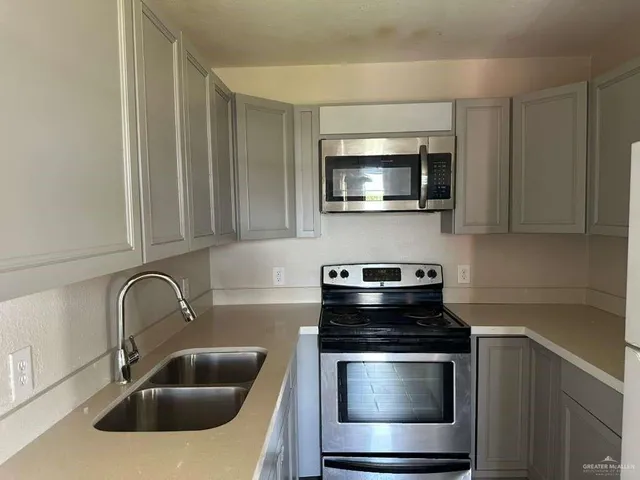 a kitchen with a stove and a sink