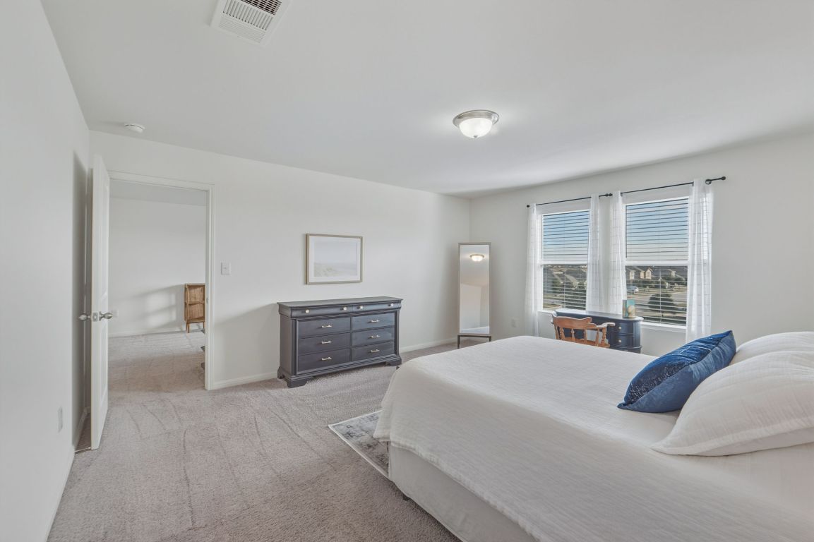 201 Wonderful Life Way Jarrell, TX 76537 - Photo 20 of 39 Spacious oversized primary bedroom. Located on upper level.