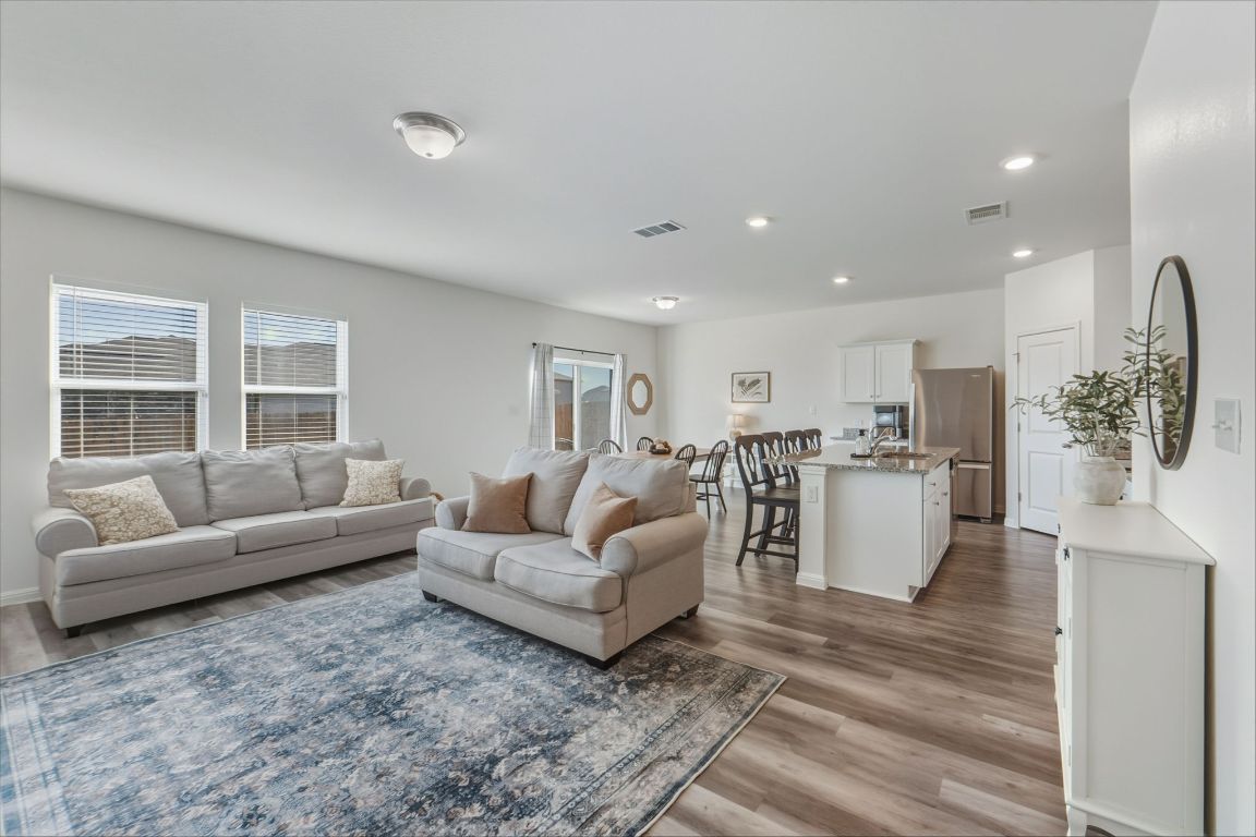 201 Wonderful Life Way Jarrell, TX 76537 - Photo 37 of 39 Living room with light wood finished floors and plenty of natural light. Open & spacious floor plan. Very functionable.