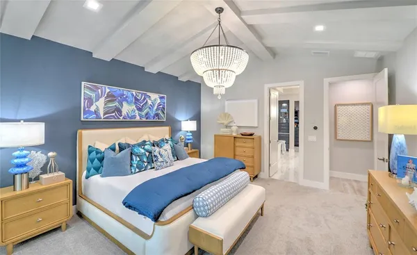 a bedroom with a bed and a chandelier