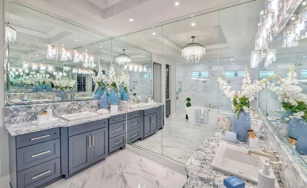 a large bathroom with a sink mirror and a shower