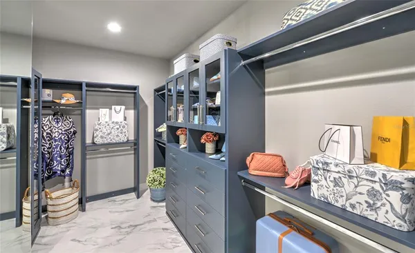 a kitchen with stainless steel appliances granite countertop a refrigerator and a wooden floor