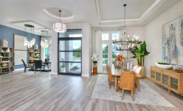 a view of a dining room with furniture and wooden floor