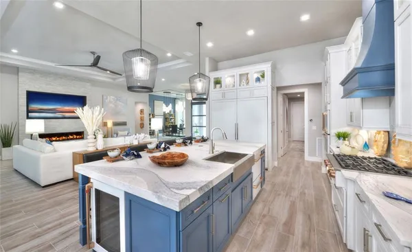 a kitchen with sink stove and living room view