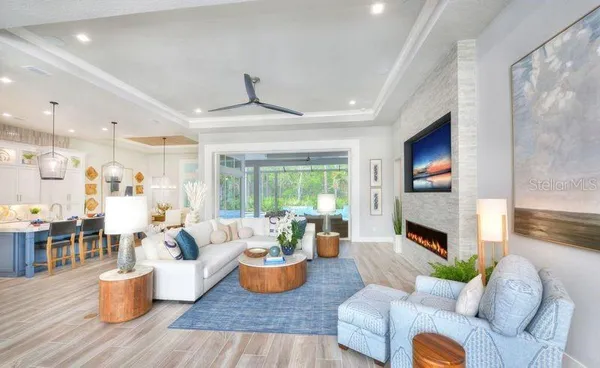 a living room with furniture fireplace and a large window