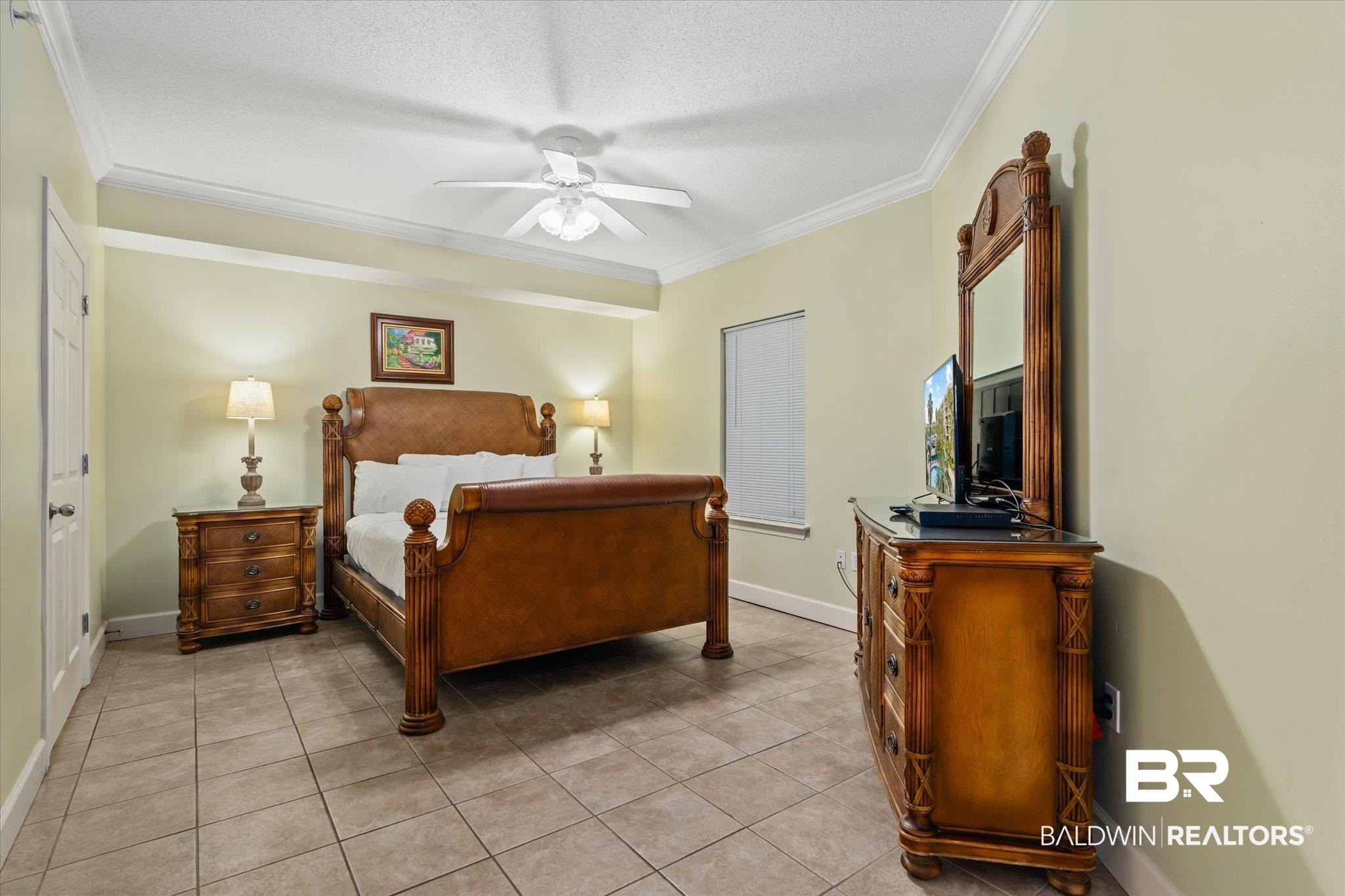 27580 Canal Road, Unit 1322 Orange Beach, AL 36561 - Photo 18 of 30 Tiled bedroom featuring ceiling fan, a textured ceiling, and ornamental molding