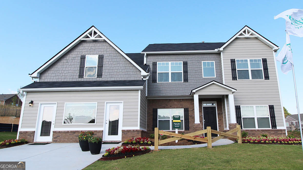 662 Ralph Still Road, Unit 42 Dacula, GA 30019 - Photo 1 of 1 a front view of a house with a yard
