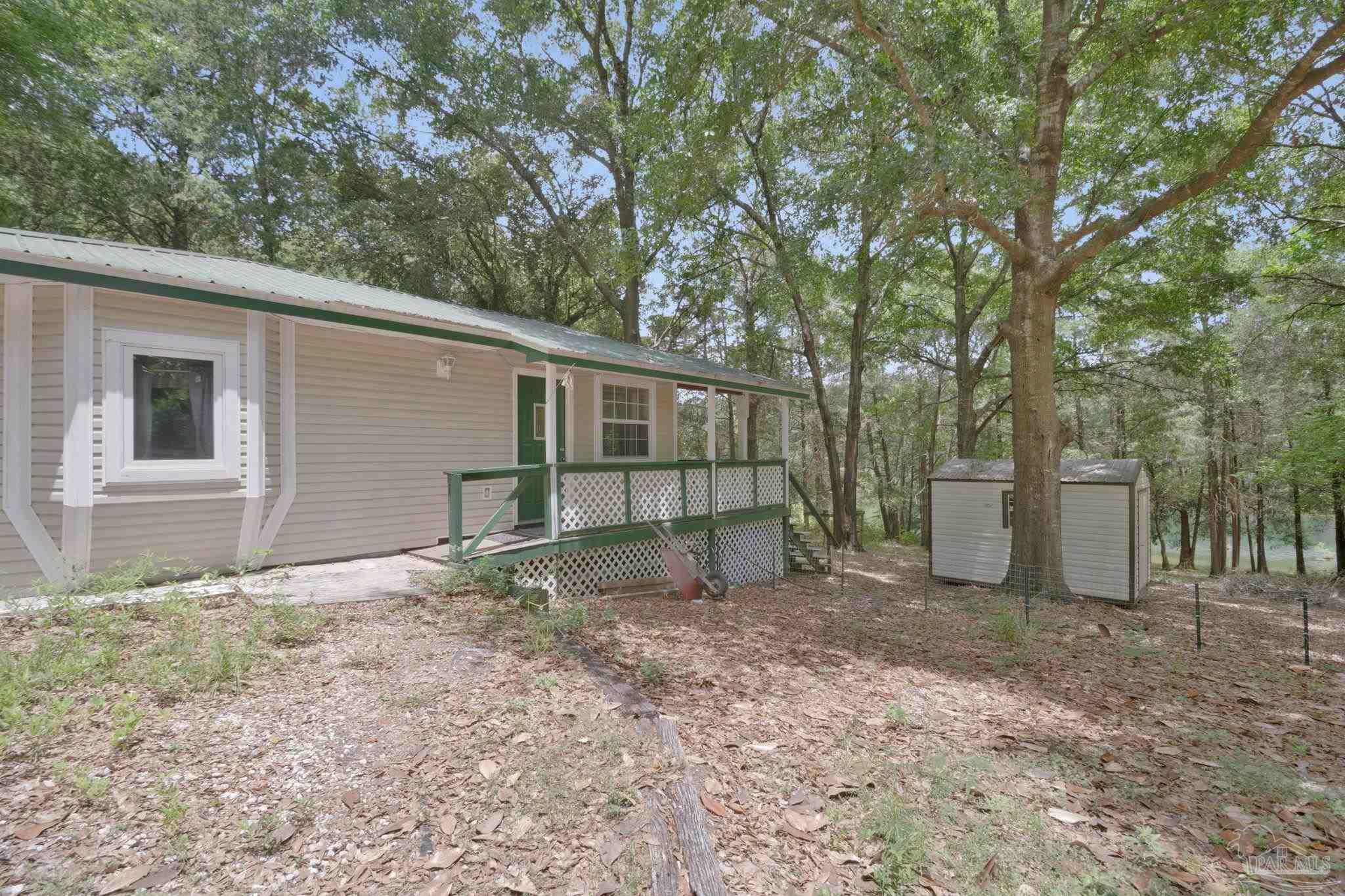 10290 West Lake Road Milton, FL 32583 - Photo 28 of 53 a backyard of a house with lots of green space