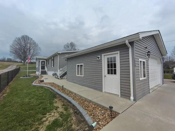 a front view of house with yard barbeque oven and barbeque oven