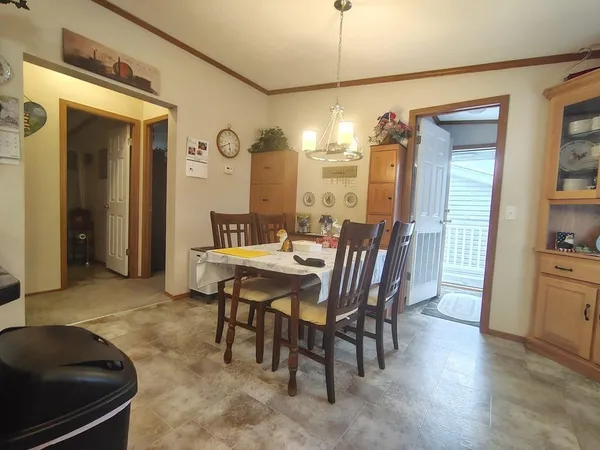 a living room with furniture a large window and a chandelier