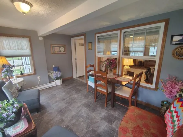 a dining room with furniture and window