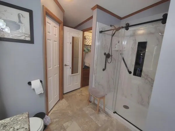 a bathroom with a glass shower door