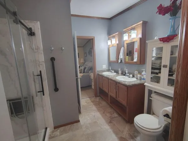 a living room with furniture or chandelier and a wooden floor