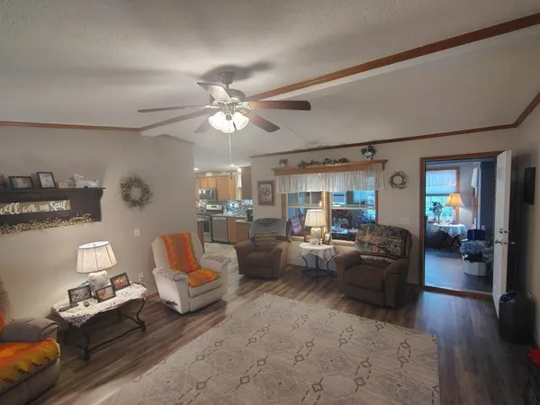 a kitchen with stainless steel appliances granite countertop a stove refrigerator sink and microwave