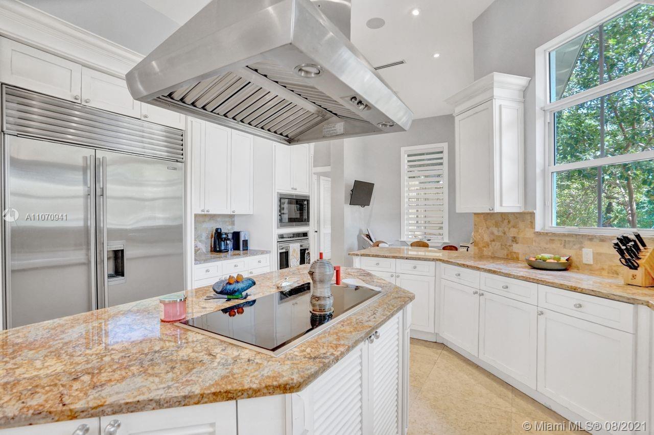 12260 Southwest 95th Avenue Miami, FL 33176 - Photo 17 of 98 a large kitchen with kitchen island a large counter space a sink a window and stainless steel appliances