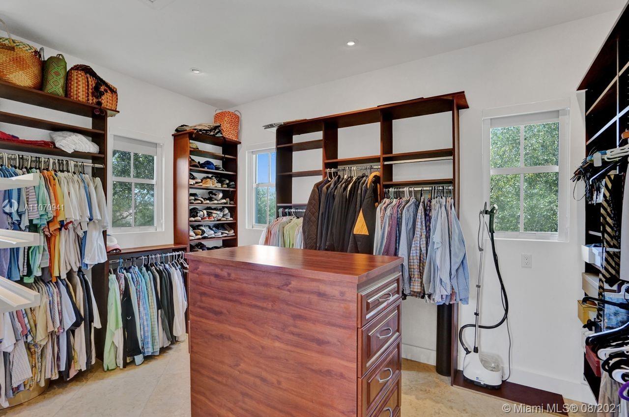 12260 Southwest 95th Avenue Miami, FL 33176 - Photo 30 of 98 a view of walk in closet with clothes and shoes
