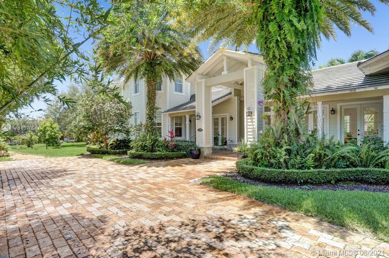 12260 Southwest 95th Avenue Miami, FL 33176 - Photo 4 of 98 a front view of a house with a garden