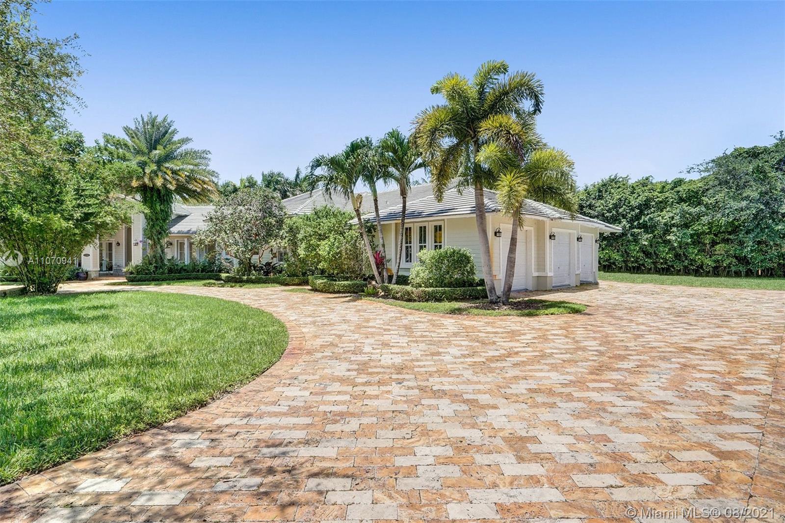 12260 Southwest 95th Avenue Miami, FL 33176 - Photo 6 of 98 a front view of a house with a yard and potted plants
