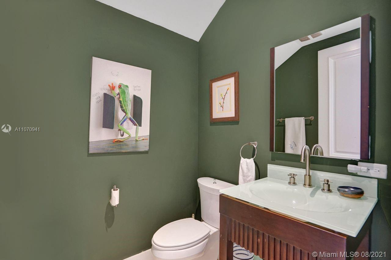 12260 Southwest 95th Avenue Miami, FL 33176 - Photo 52 of 98 a bathroom with a toilet a sink and mirror