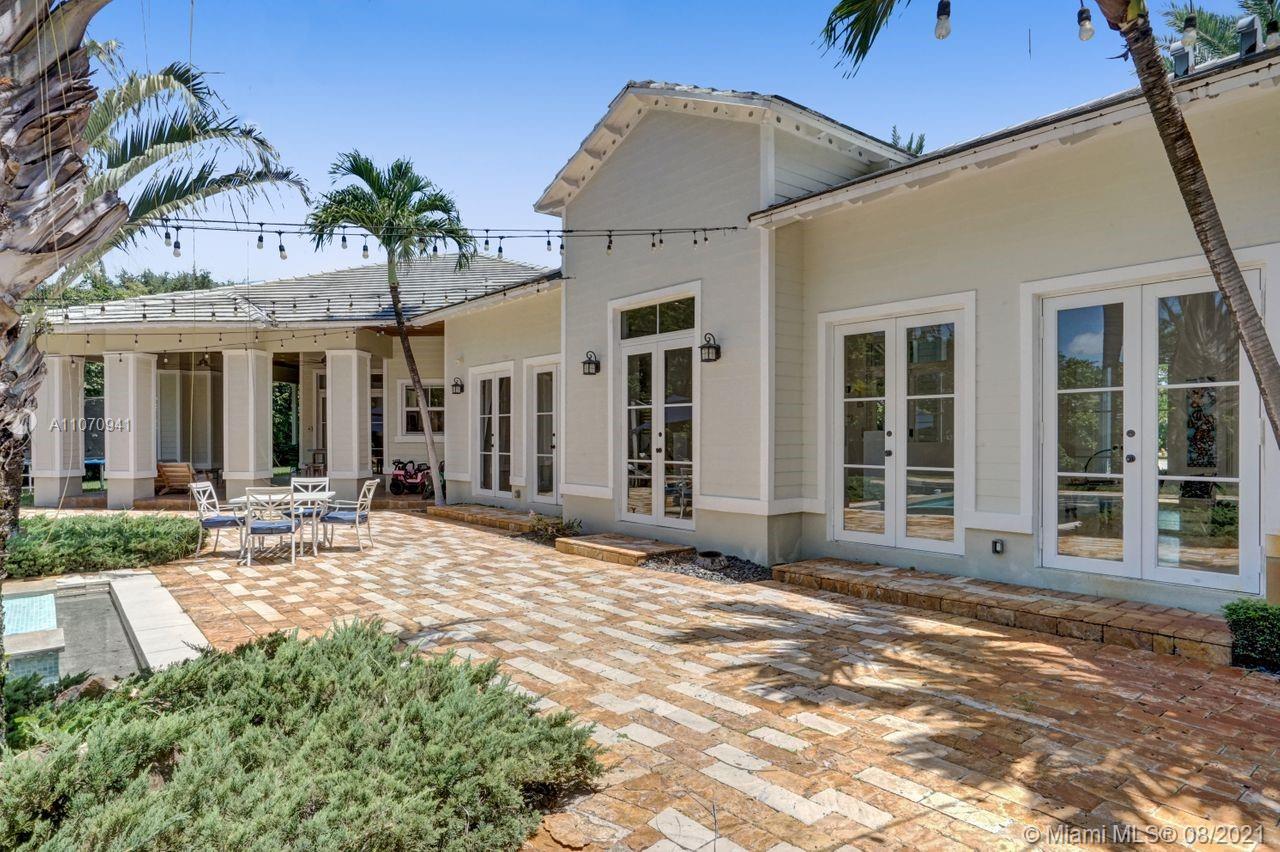 12260 Southwest 95th Avenue Miami, FL 33176 - Photo 86 of 98 a view of a house with a patio and a yard