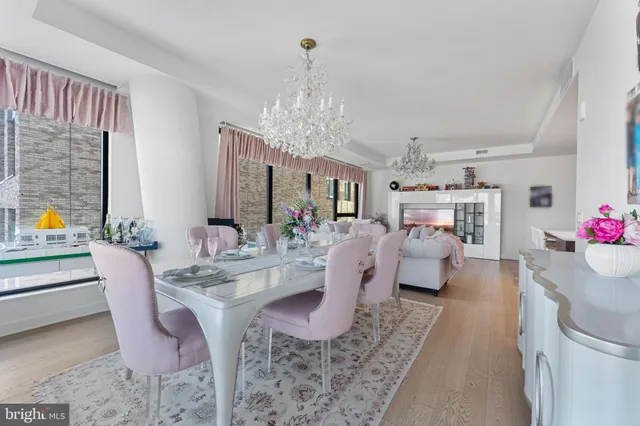 a living room with furniture and a chandelier