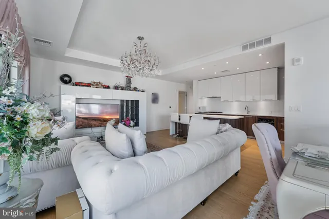 a living room with furniture and a chandelier