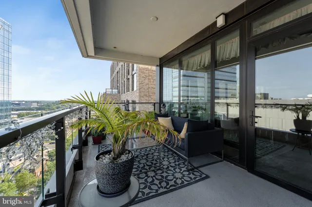a view of a balcony with chairs and wooden floor