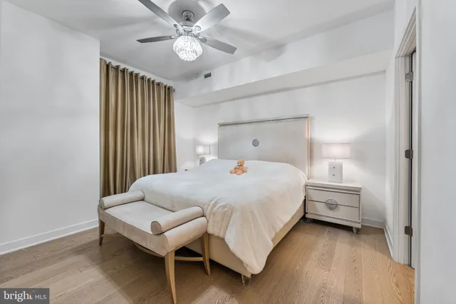 a bedroom with a bed and a chandelier
