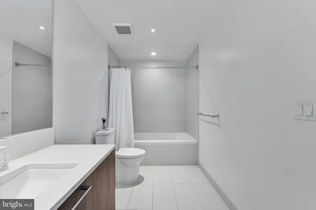 a bathroom with a double vanity sink mirror and