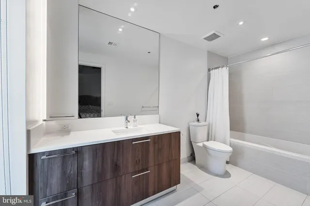 a bedroom with a bed and a chair