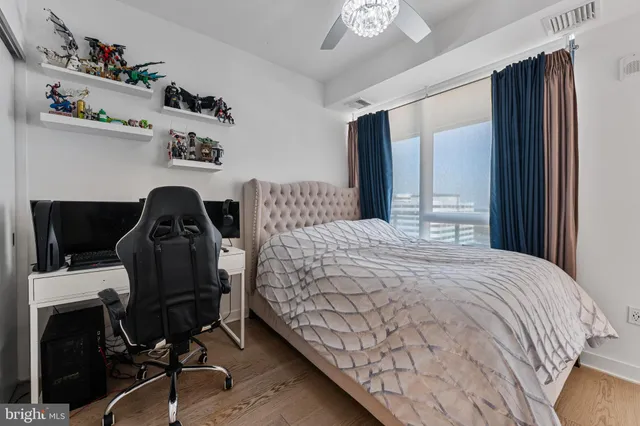 a bedroom with a bed and a chandelier