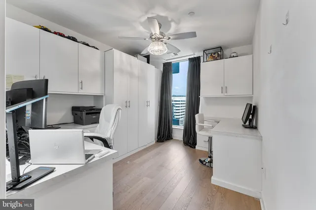 a view of a workspace with furniture and a flat screen tv