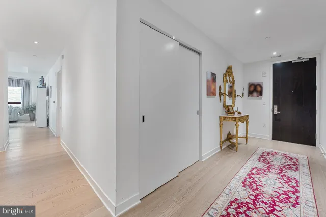 a living room with kitchen island furniture and a chandelier