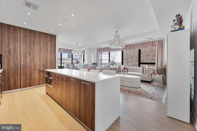 a large white kitchen with stainless steel appliances