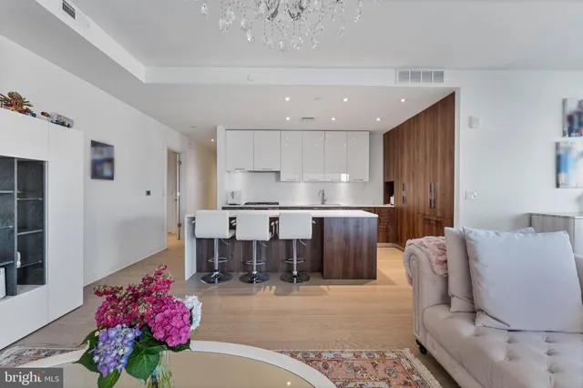 a living room with stainless steel appliances furniture and a large window