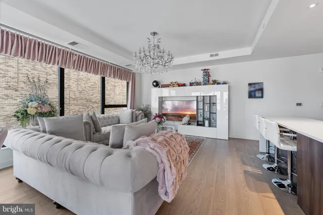 a living room with furniture and a chandelier