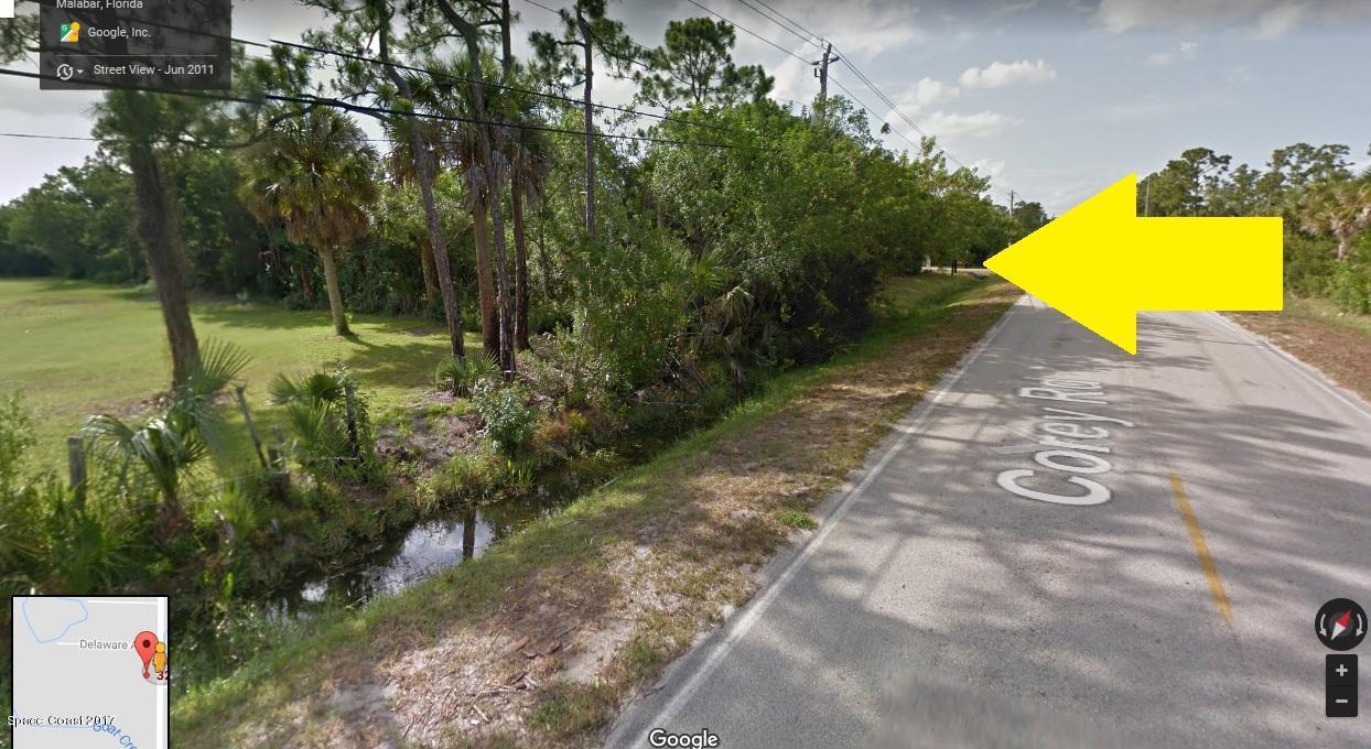 0 West Of Corey And Benjamin Road Malabar, FL 32950 - Photo 6 of 7 a view of a house with a yard and swimming pool