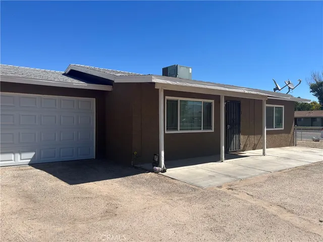 a kitchen with refrigerator and sink