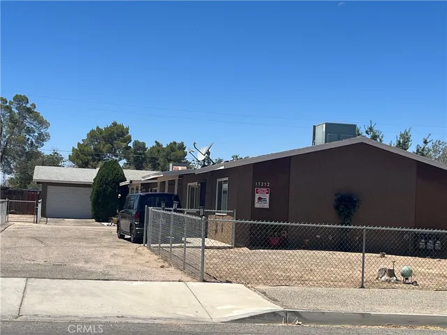 a view of a house with wooden fence