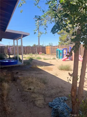 a room with wooden floor and outdoor view