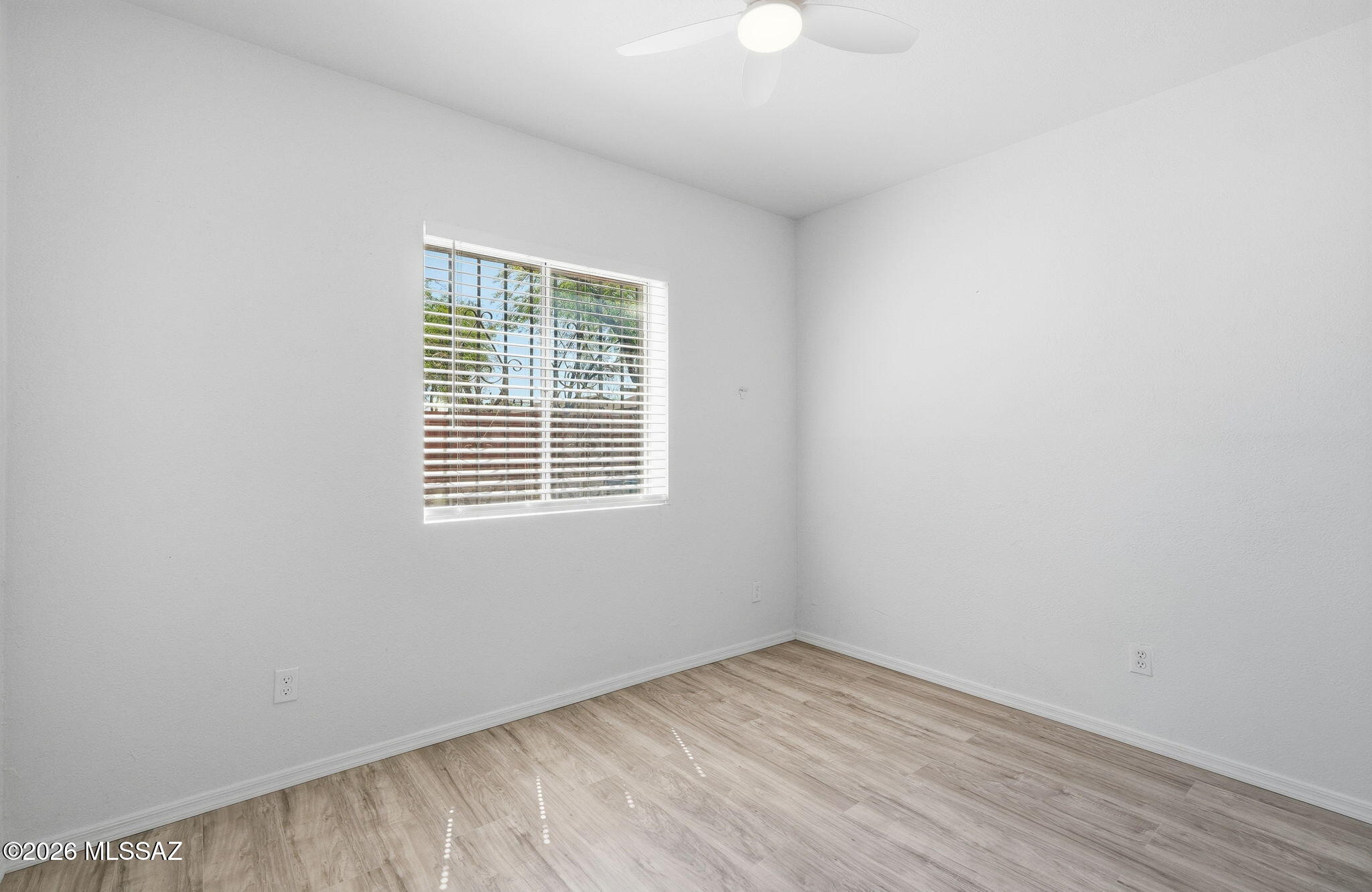 136 West Elvira Road Tucson, AZ 85756 - Photo 19 of 27 wooden floor in an empty room with a window
