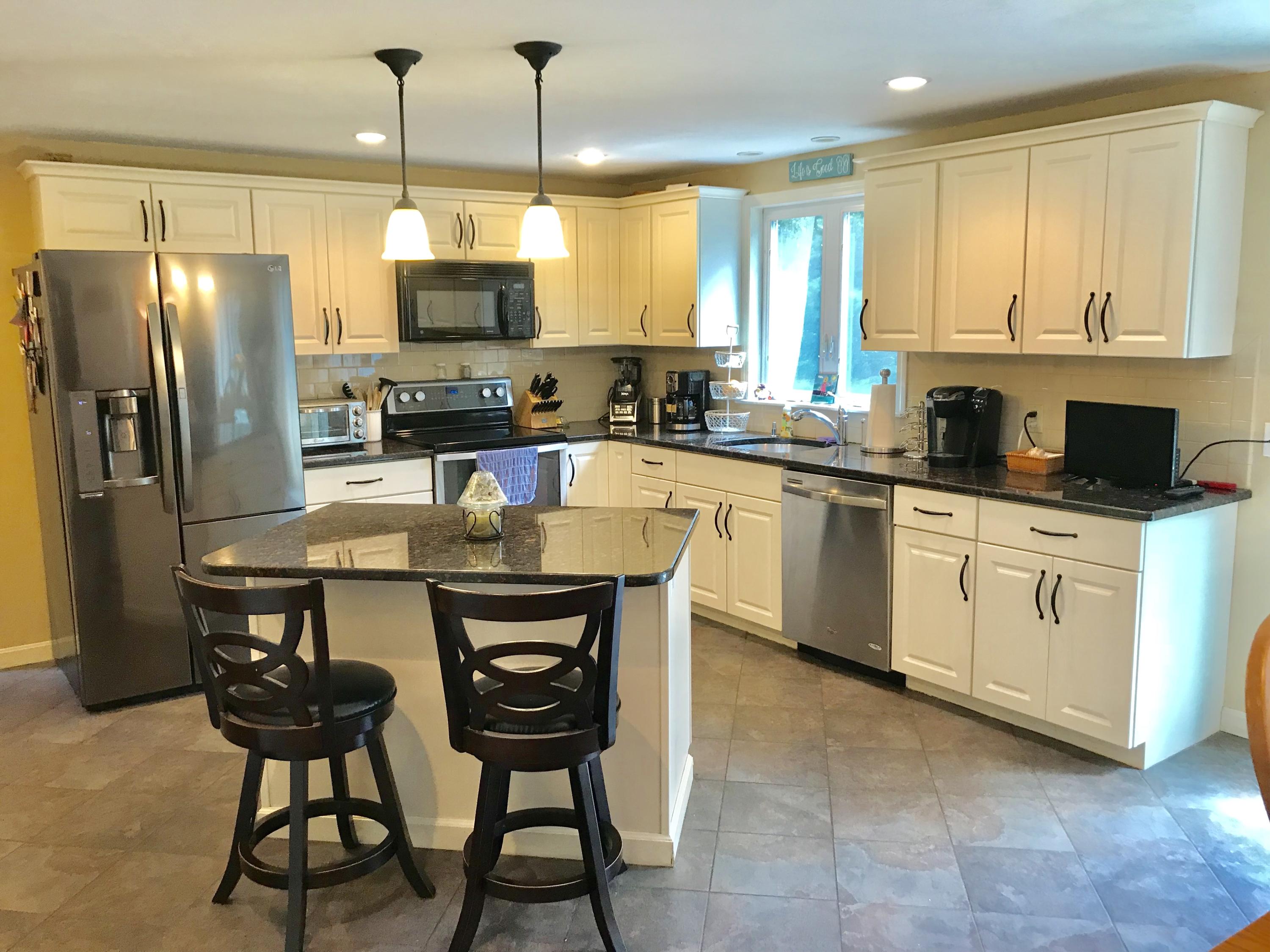44 Pimlico Pond Road Forestdale, MA 02644 - Photo 2 of 28 a kitchen with stainless steel appliances granite countertop a stove a sink a microwave a refrigerator and chairs
