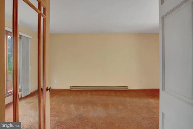 a view of a room with wooden floor