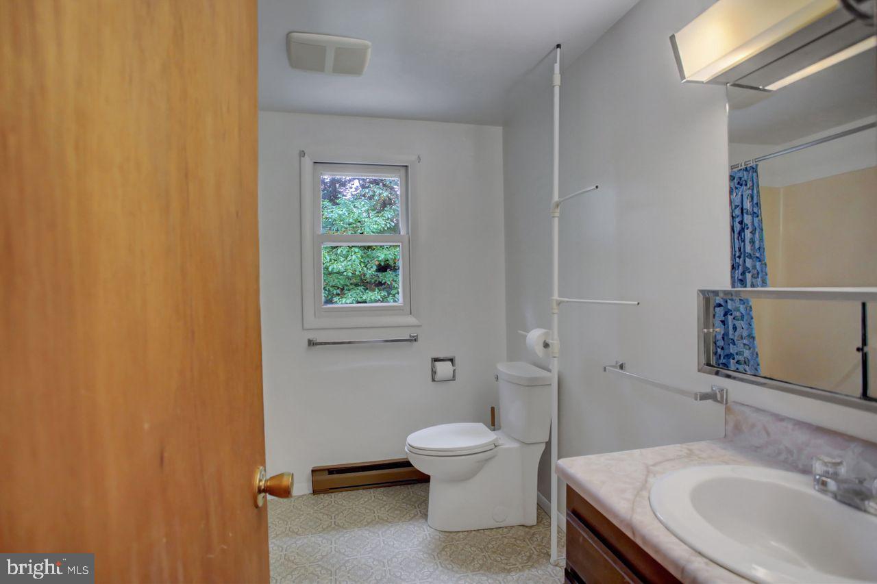 721 Narrows Road Biglerville, PA 17307 - Photo 25 of 40 a bathroom with a granite countertop toilet a sink and a mirror