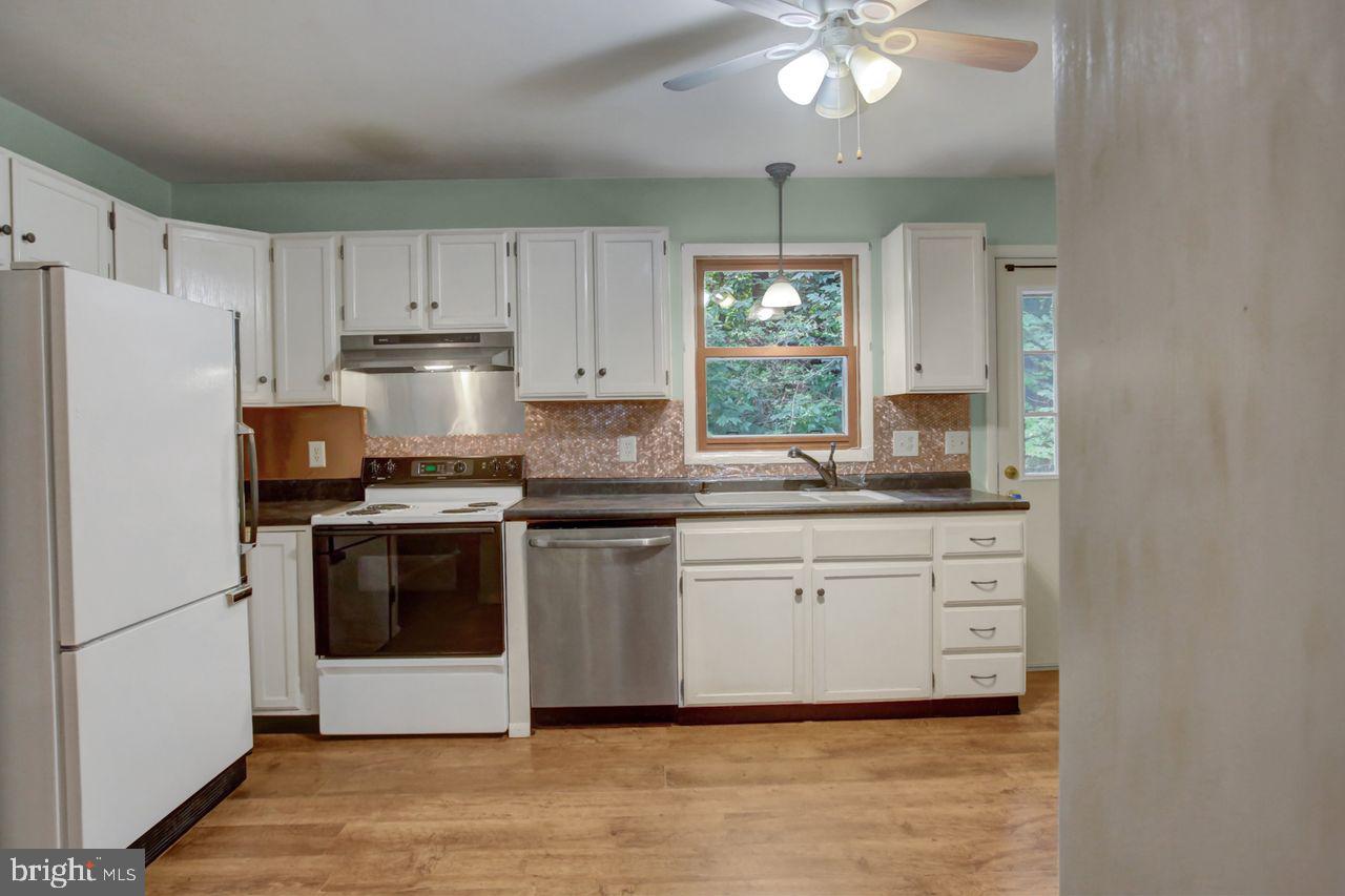 721 Narrows Road Biglerville, PA 17307 - Photo 10 of 40 a kitchen with stainless steel appliances granite countertop a stove a sink and a refrigerator