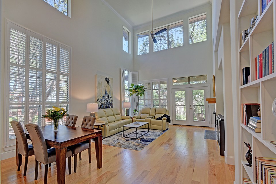 a living room with furniture wooden floor and a large window
