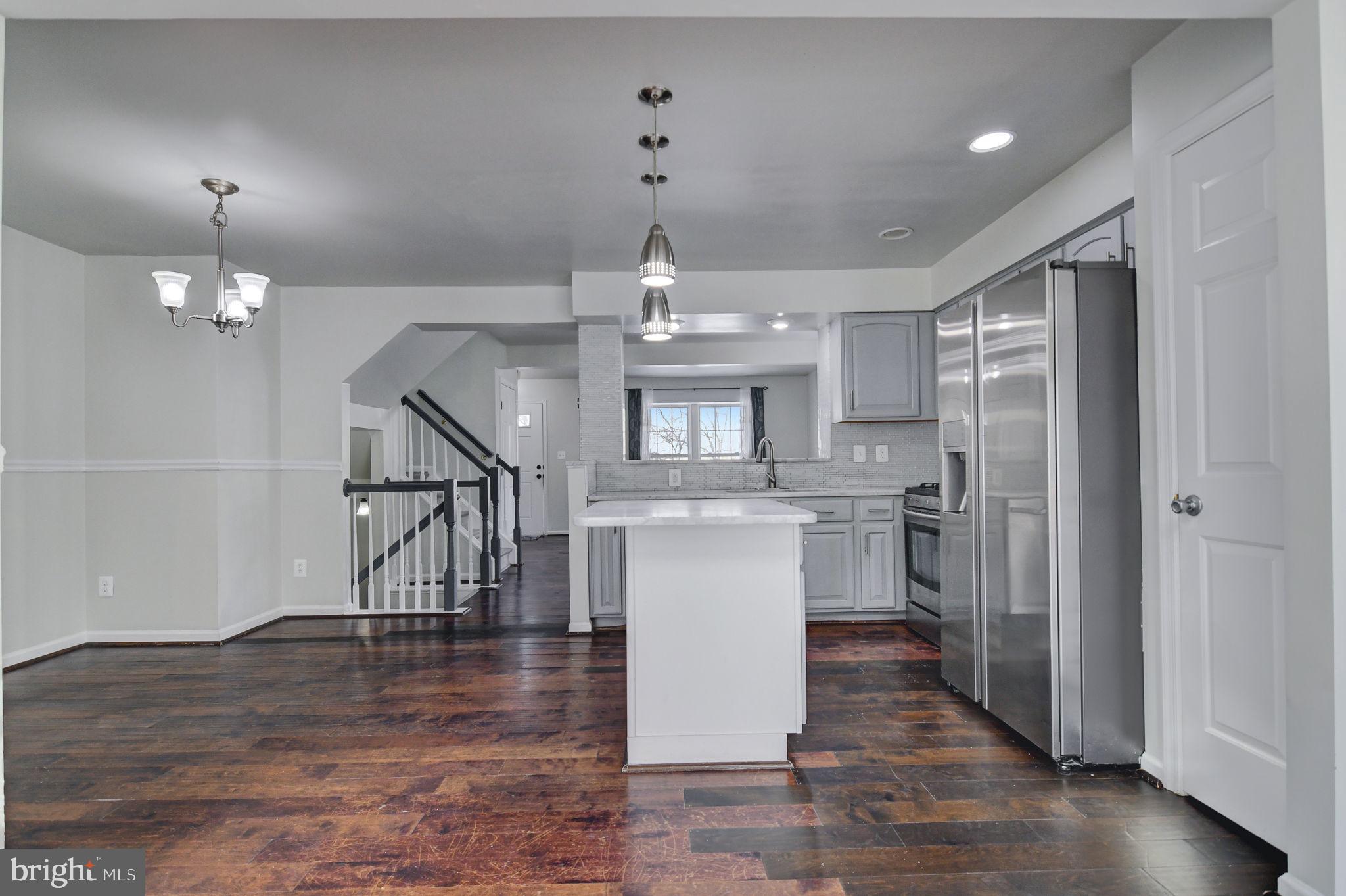4013 Mammoth Cave Loop Dumfries, VA 22025 - Photo 13 of 38 a kitchen with kitchen island a sink stainless steel appliances and cabinets