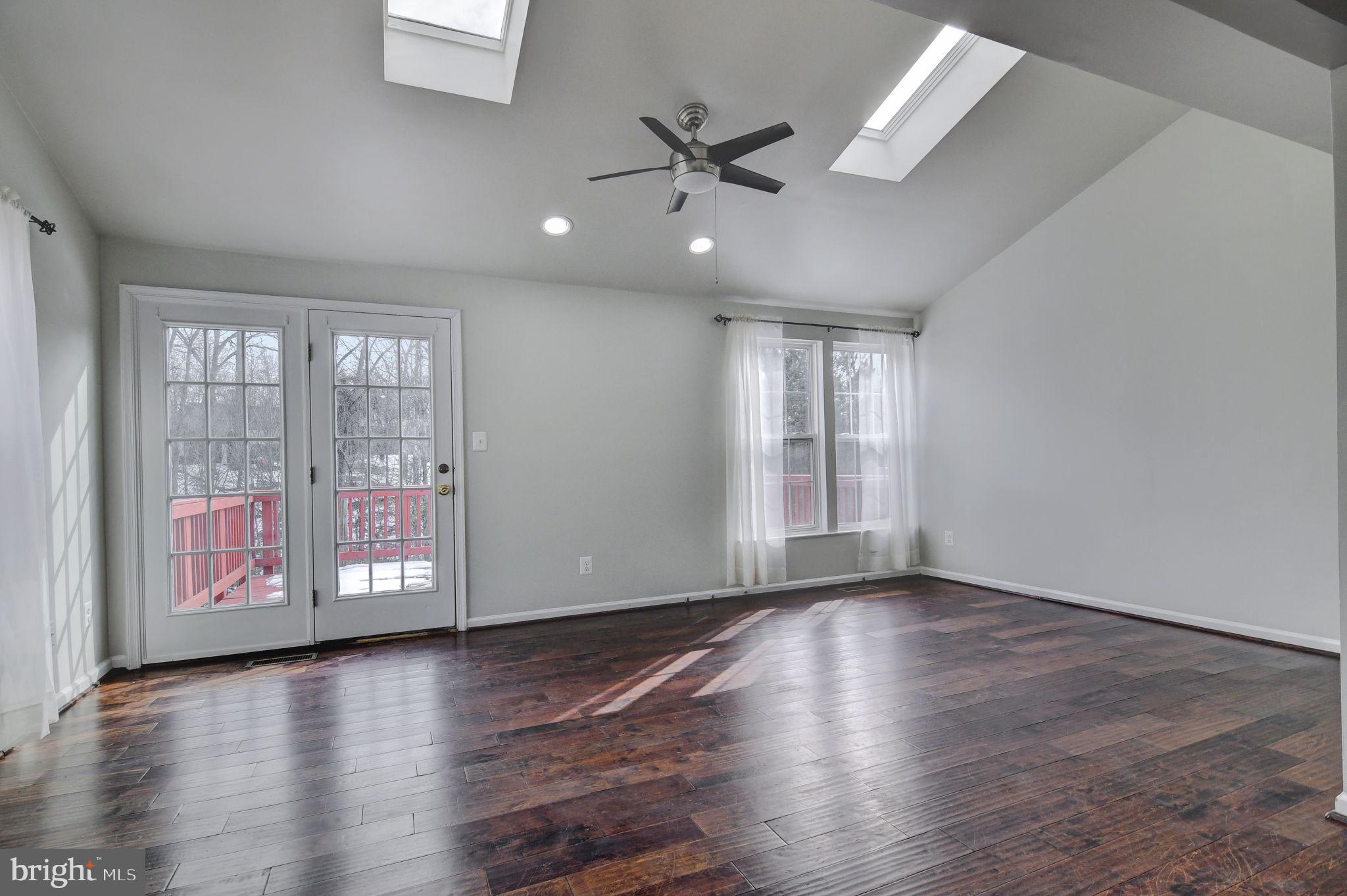 4013 Mammoth Cave Loop Dumfries, VA 22025 - Photo 14 of 38 a view of an empty room with a window and wooden floor