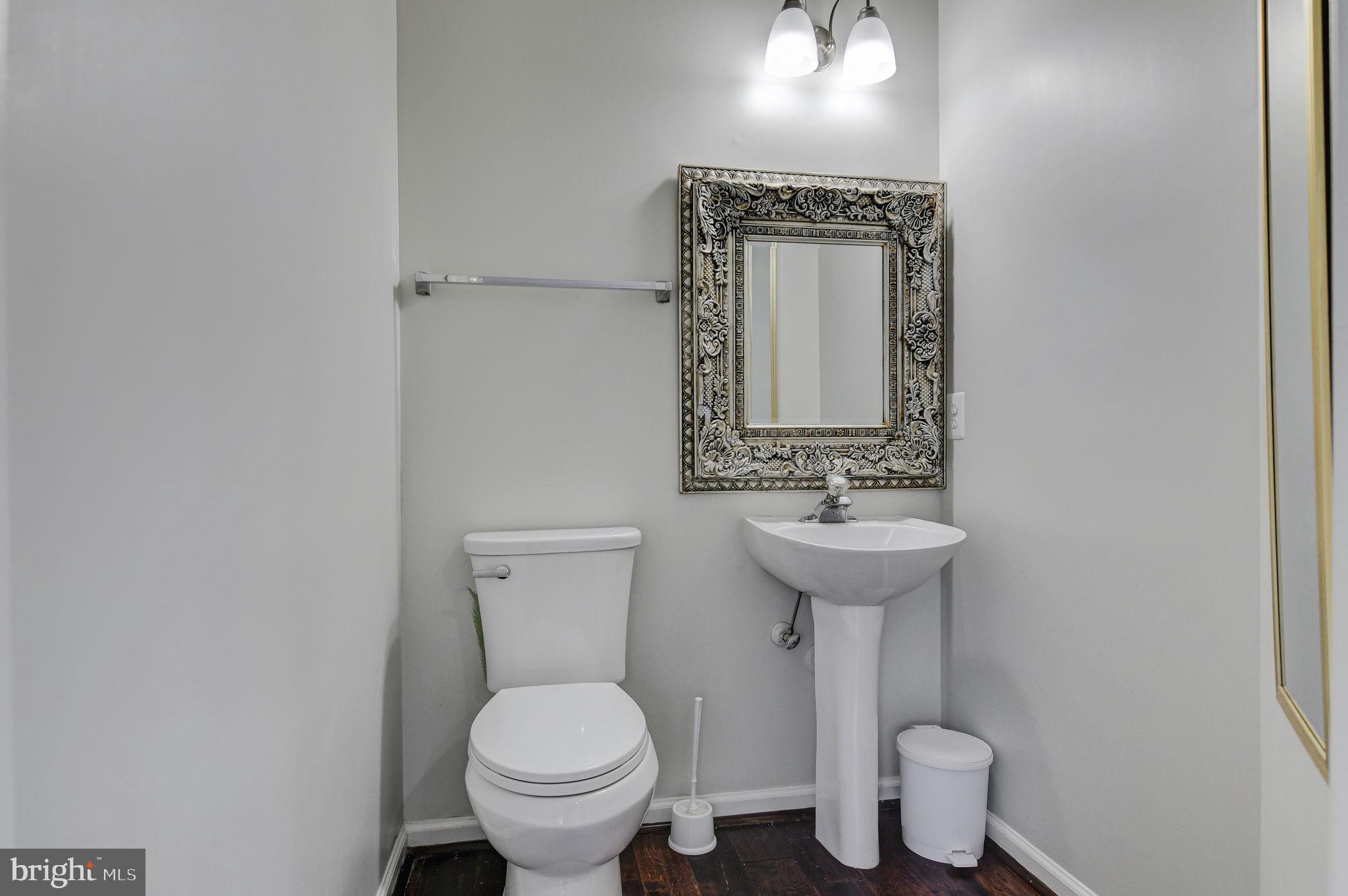4013 Mammoth Cave Loop Dumfries, VA 22025 - Photo 15 of 38 a bathroom with a toilet sink and mirror